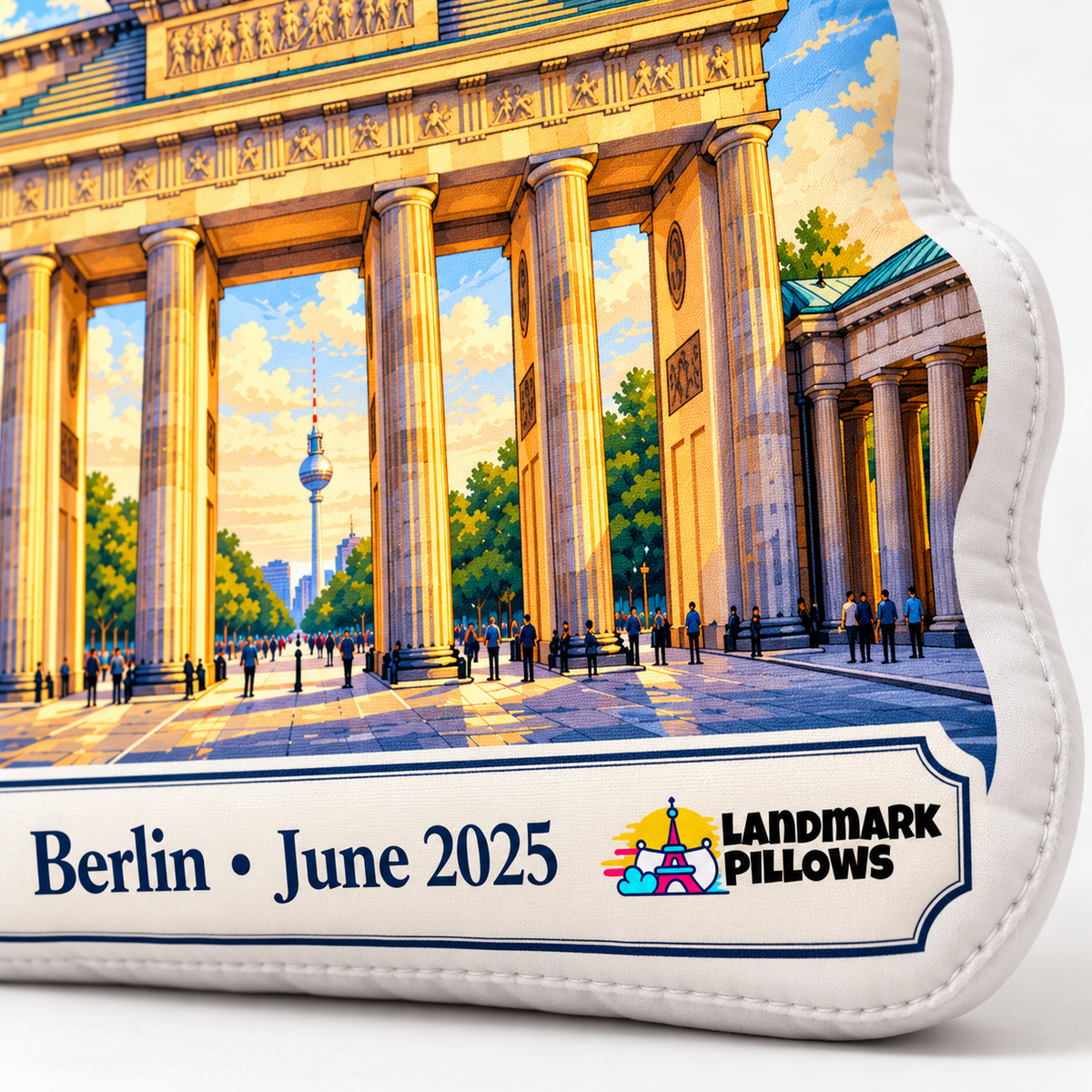 Close-up of Brandenburg Gate pillow personalization plaque reading Berlin June 2025 with Landmark Pillows logo